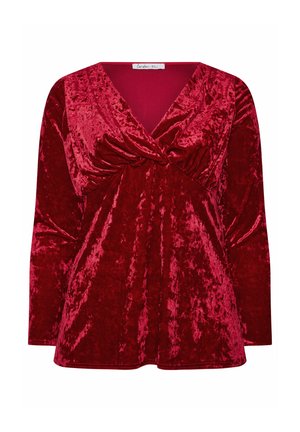 Rotes Samtoberteil mit tiefem V-Ausschnitt, langen Ärmeln und Raffung am Brustbereich. Glatte Textur mit glänzender Oberfläche.
