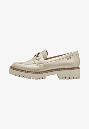 Beige leren loafer met een gouden hardwareaccent, met een dikke, robuuste zool en gedetailleerde stiksels langs de bovenrand.