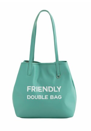 Bolso tote sintético turquesa con dos asas, que presenta el texto "BOLSO DOBLE AMISTOSO" en letras blancas en negrita en la parte frontal.