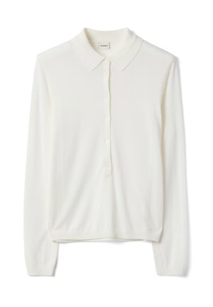 Roomkleurig poloshirt met lange mouwen gemaakt van zachte stof, voorzien van een kraag en zes knoopsluitingen. Geribbelde boorden en zoom.