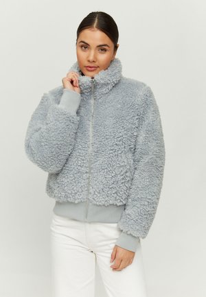 Light grey, fuzzy zip-up jacket with a high collar, ribbed cuffs, and hem. Soft texture and rounded, cropped design.