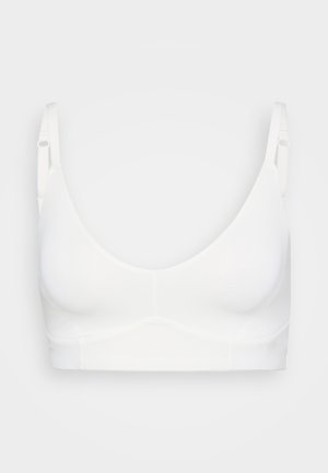 Fehér vezeték nélküli melltartó sima, varrat nélküli kosarakkal, állítható pántokkal és széles derékrésszel a támogatás érdekében. Puha anyag, matt felülettel.