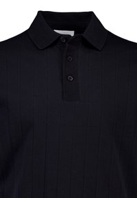 Polo nera con colletto, dotata di una patta con cinque bottoni, trama verticale a coste e maniche corte.