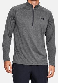 Grauer Langarm-Quarter-Zip-Pullover mit strukturiertem Stoff, kontrastierendem dunklem Reißverschluss und Under Armour-Logo auf der Brust.