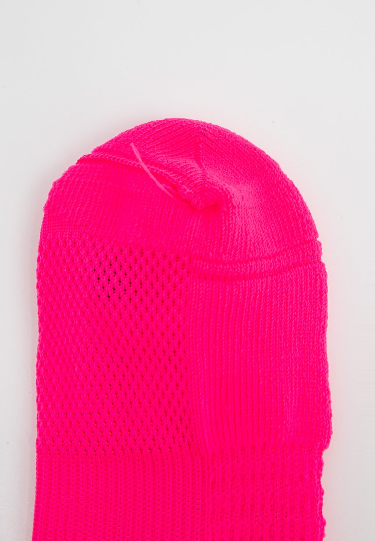 Neon-pinke Socke mit einem atmungsaktiven Netzbereich, glatter Textur und gerippten Akzenten am Bund, entworfen für Komfort und Passform.
