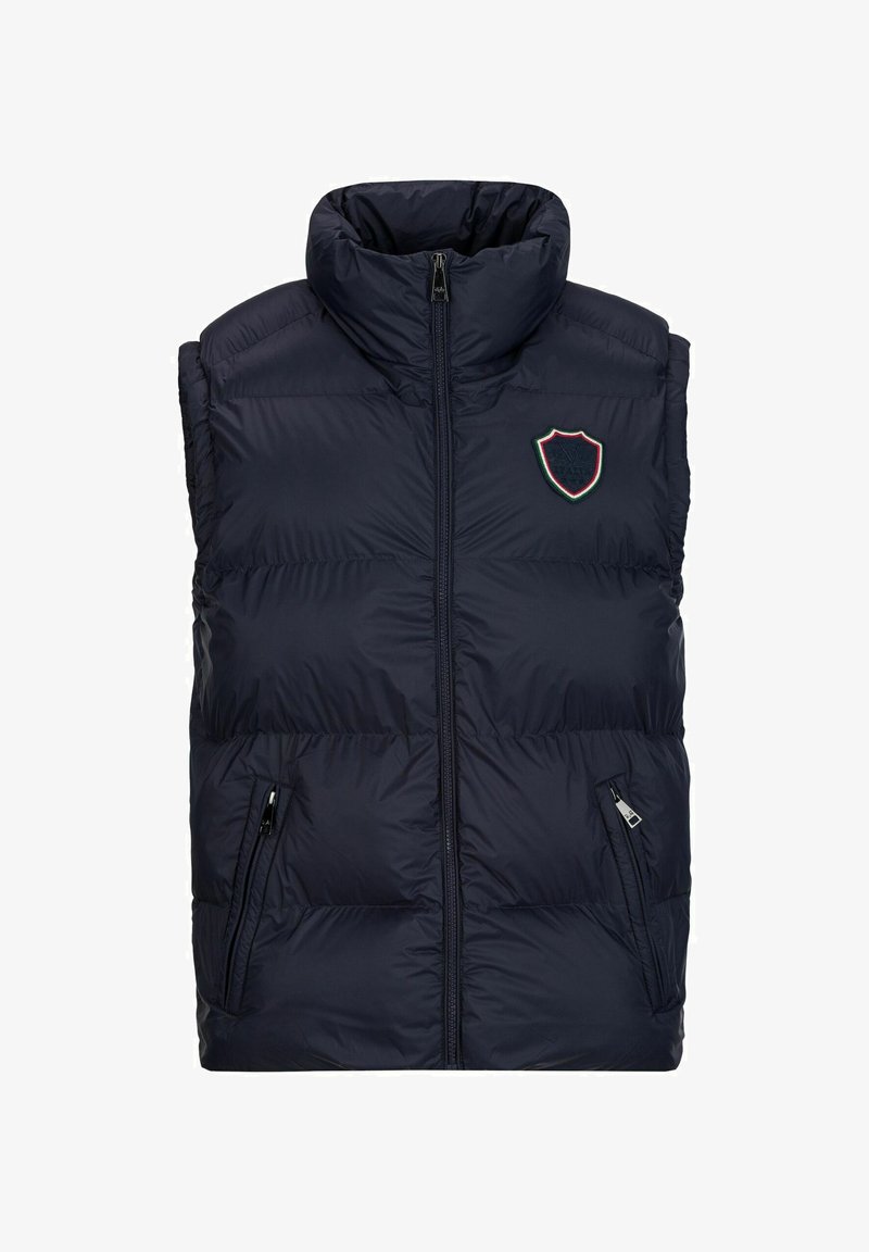 Marineblauer Steppweste mit hohem Kragen, Reißverschluss und zwei Seitentaschen. Mit gesticktem Wappenemblem in Rot, Weiß und Grün.