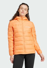 Orange padded jacket with a hood, horizontal quilted pattern, front zip closure, and a small logo on the left chest. Smooth, lightweight fabric.
