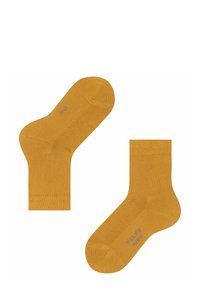 Deux chaussettes jaune moutarde posées à plat, mettant en avant leur texture lisse et leur courte longueur, avec une petite étiquette visible sur une des chaussettes.