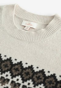 Helles graues Strickpullover mit einem geometrischen braunen und schwarzen Muster am Saum. Gerippter Rundhalsausschnitt und strukturierter Stoff. Markenlabel sichtbar.