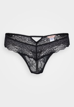 Black lace thong with floral pattern, scalloped edges, and a V-shaped front cutout. Features a soft waistband and minimal back coverage.