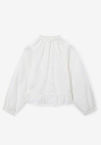 White long-sleeve top with textured floral pattern, gathered neckline, and a peplum bottom. Material appears lightweight and breathable.