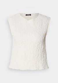 Débardeur blanc sans manches avec un motif texturé et froissé, présentant un décolleté en V et une coupe décontractée, légèrement resserrée au niveau de l'ourlet.