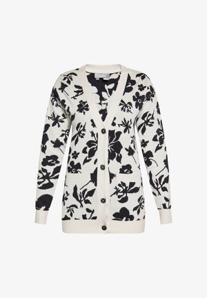Strickjacke in Cremetönen mit einem schwarzen Blumenmuster. Verfügt über einen V-Ausschnitt, Frontknöpfen und zwei vorderen Taschen. Weicher Stoff.