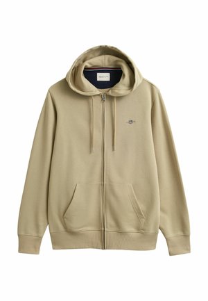 Beige zip-up hoodie met zakken aan de voorkant, capuchon met trekkoord, geribbelde manchetten en een klein geborduurd logo op de linkerkant van de borst.