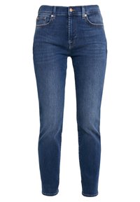 Tummansiniset farkut, joissa on slim fit -malli, viisi taskua ja kontrastivärinen ompelu. Varustettu vetoketjulla ja metallinapilla vyötäröllä.