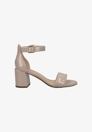 Beige patent leather block-heel sandal with a wide toe strap and a narrow ankle strap featuring a square metal buckle.