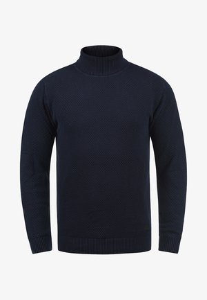 Pull en col roulé bleu marine en tricot texturé, avec des poignets et un ourlet côtelés, offrant une coupe ajustée sur tout le corps.