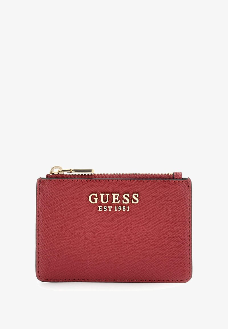 Red textured leather Guess cardholder with gold logo and zipper on top.