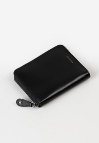 Black leather wallet with a zip closure, smooth texture, rectangular shape, and a small loop with a snap for secure handling.