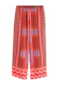 Rote gemusterte weit geschnittene Hose mit geometrischen und floralen Designs. Besitzt einen elastischen Bund und einen Zickzack-Akzent am Saum.