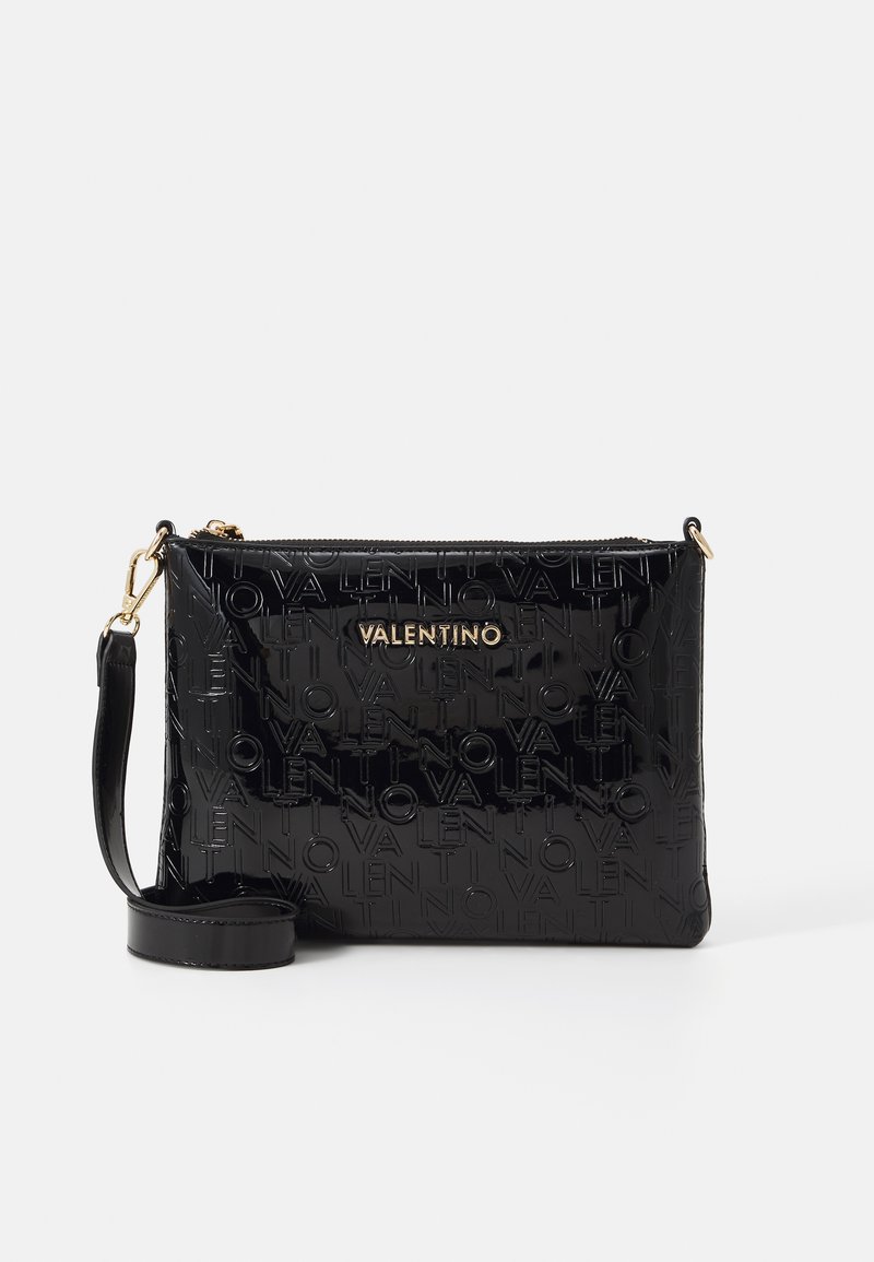 Black patent leather clutch with embossed "Valentino" logo, gold hardware, detachable strap, rectangular shape, and zipper closure.
