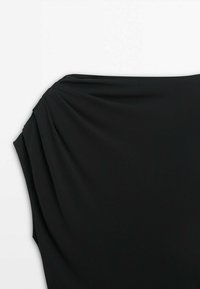 Haut noir sans manches avec un détail de tissu froncé près de l'épaule sur un fond blanc uni.