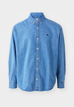 Denim button-up shirt, light blue in color, with a point collar, long sleeves, and a small logo on the chest. Features white buttons and stitched seam.