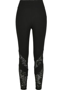 Leggings noirs avec des insertions en dentelle sur les côtés. Tissu doux et extensible avec un design ajusté et une taille élastique.