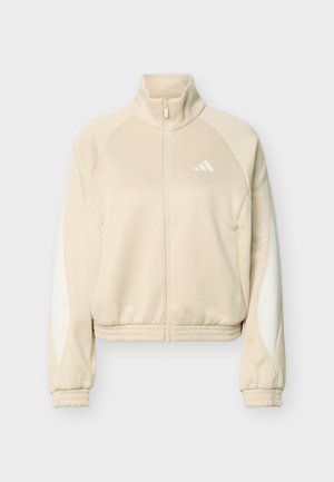 Jasnobeżowa kurtka na zamek z wysokim kołnierzem, elastycznymi mankietami i dołem, białe boczne paski na rękawach oraz małe logo na piersi.