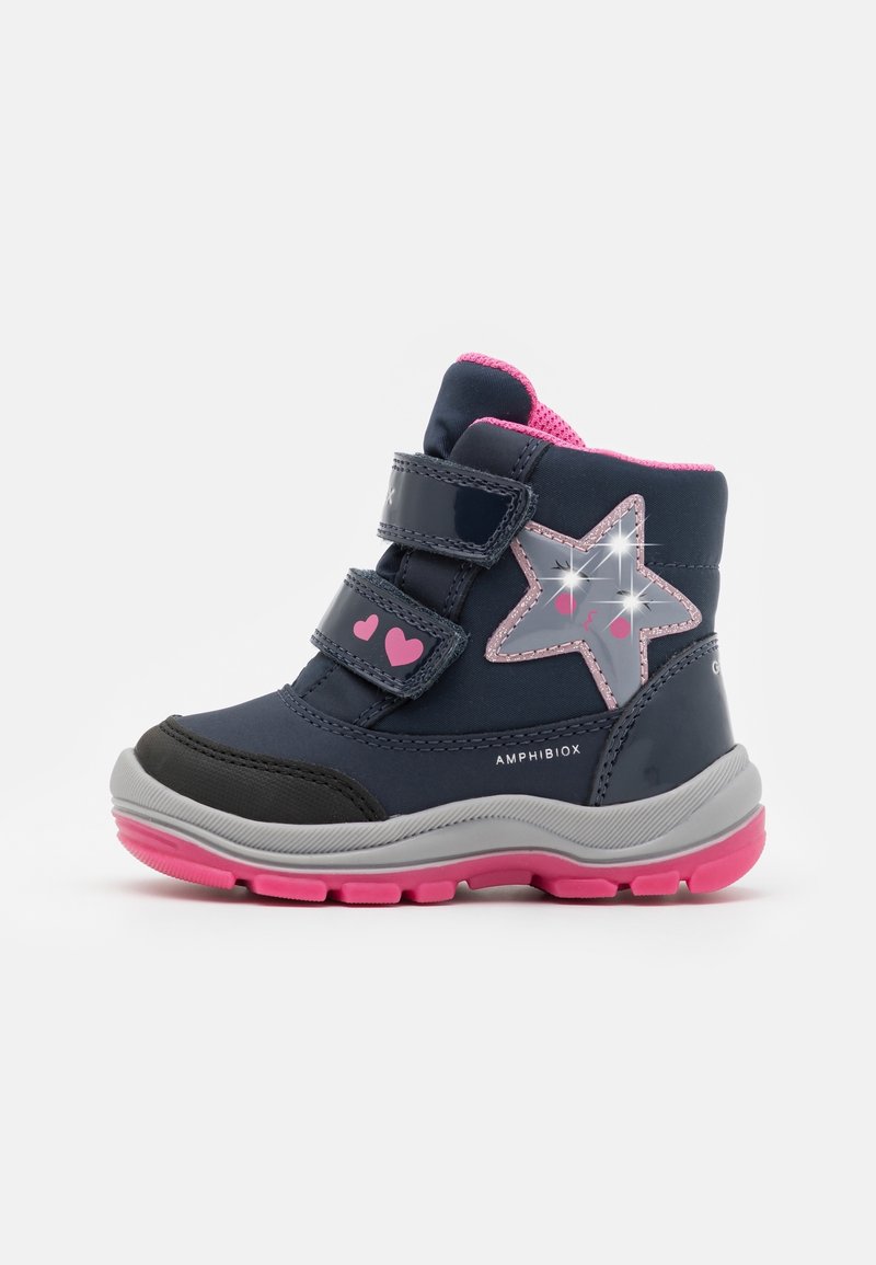 Navy blue ankle boots with pink accents, featuring two adjustable velcro straps, a star design, and grey rubber sole with pink tread.