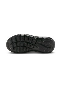 Suela de zapato de goma negra con patrones de tracción circulares y rectangulares, con motas doradas y un logo de Nike. Superficie texturizada para un mejor agarre.