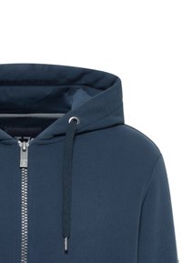 Dunkelblauer Reißverschluss-Hoodie mit Kordelzugkapuze, silbernen Hardware-Details und einem glatten Textil. Das Design umfasst eine kontrastierende Innenauskleidung.