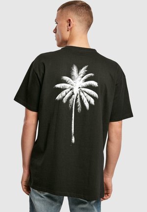 Sort bomulds T-shirt med et stort hvidt palmetræ grafik på ryggen, korte ærmer og en afslappet pasform. Casual design og tekstur.