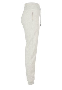 Helle graue Sweatpants aus weichem Material mit einem elastischen Bund und Kordelzug, seitlichen Taschen und schmalen Bündchen.