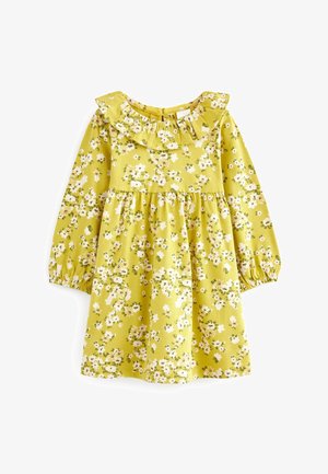 Robe jaune à manches longues pour tout-petit avec motif floral blanc, col volanté et poignets élastiques, étalée à plat sur un fond blanc.