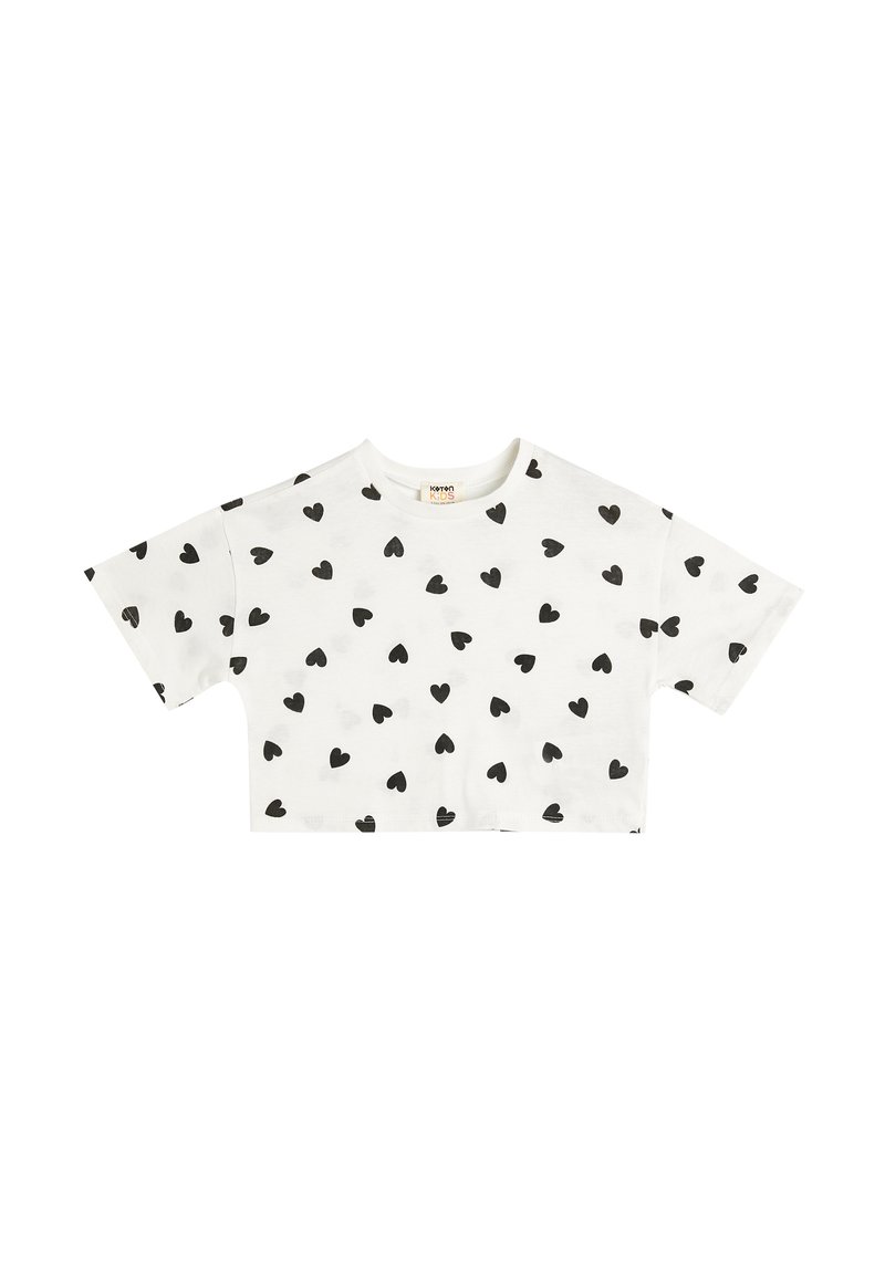 Kortærmet t-shirt i hvid bomuld med sorte hjerte-mønstre overalt. Rund udskæring med en afslappet pasform.