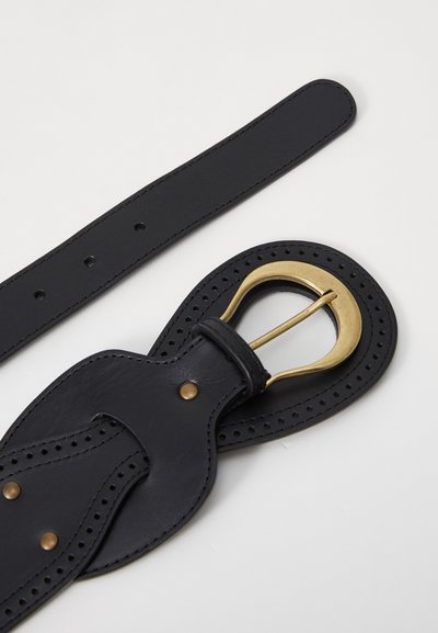 Svart skinnbelte med perforert design, med en gullmetallspenne og nagleaccent. Stroppen er flat og glatt med presise sømmer.