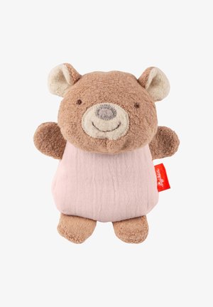 Small brown teddy bear plush with smiling face, round ears, and pink fabric body with red tag on the side.