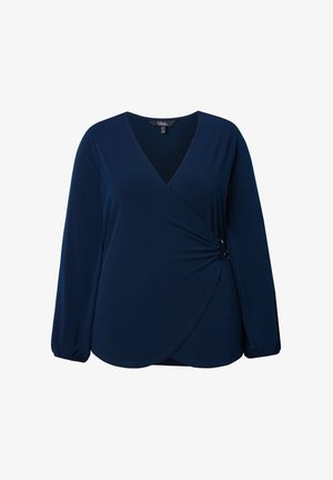 Tummansininen pitkähihaisella kietaisupaidalla, joka on valmistettu pehmeästä materiaalista. Paidassa on V-aukko, kiertävä etuosa ja elastiset hihansuut.