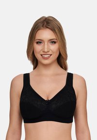 Black bra featuring lace detailing around the cups, thick straps for support, and a decorative bow at the center.