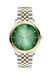 Montre ronde avec un cadran dégradé vert, des index heures dorés, une lunette dorée et un bracelet en métal bicolore argent et or.