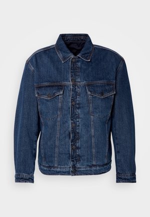 Dark blue denim jacket with a collared neck, two chest pockets, and button closure. Features a slightly unstructured fit and visible stitching.