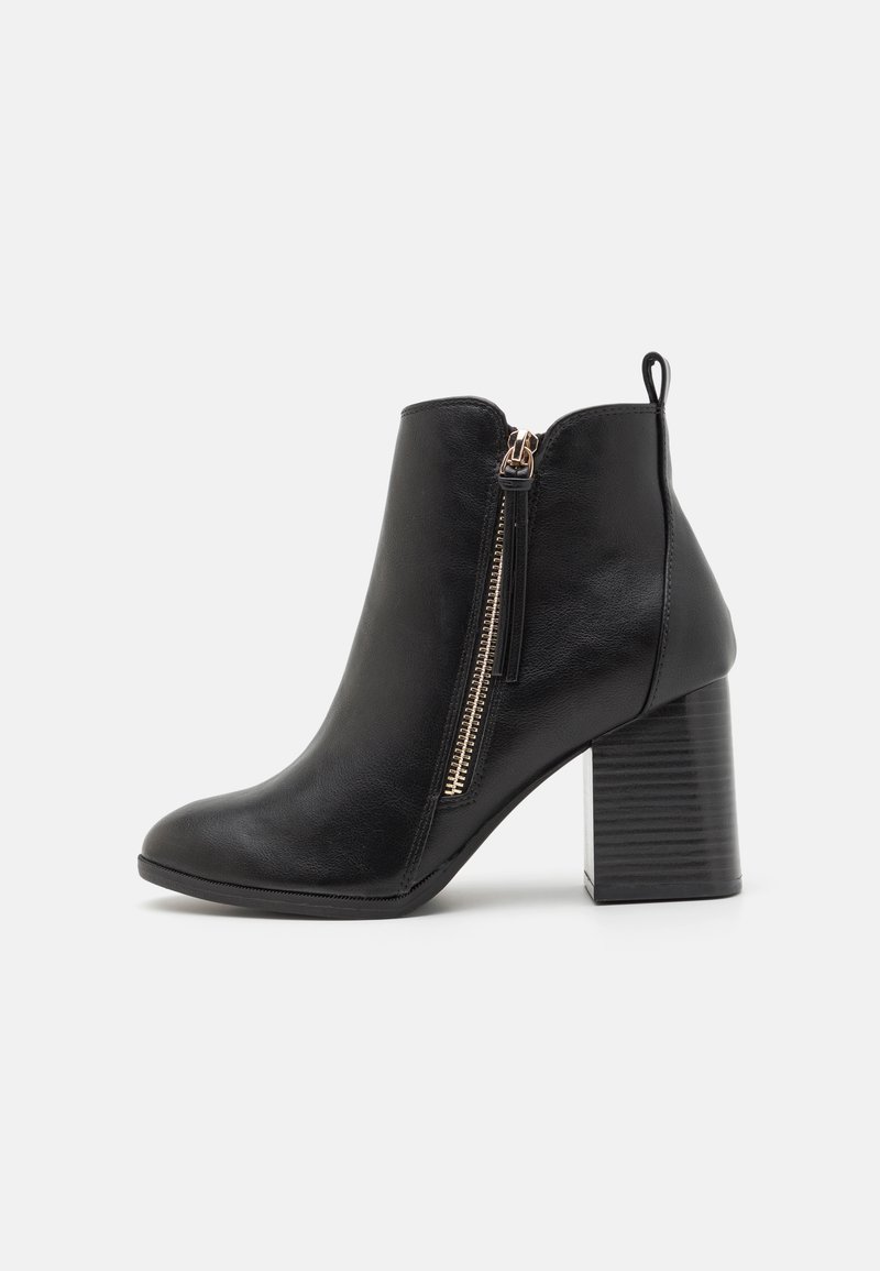 Stivaletto nero in pelle liscia con zip laterale, caratterizzato da un tacco a blocco rigido e una linguetta sul retro.