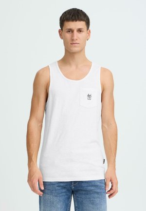 White cotton tank top with a round neck and a chest pocket featuring a small graphic. Worn with blue denim jeans.