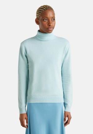 Light blue turtleneck sweater in a soft texture, featuring long sleeves and a ribbed hem, complemented by a smooth blue skirt.