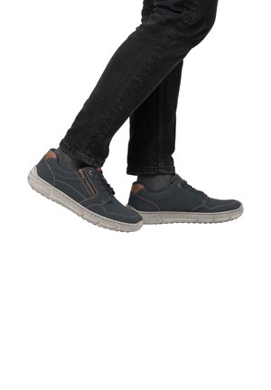 Navy blue sneakers with a textured finish, grey rubber sole, and brown accents. Features lace-up closure and a side zipper detail.