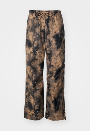 Brune og svarte tie-dye bukser med vide ben, elastisk midje og snor. Har frontlommer og teksturert stoff.