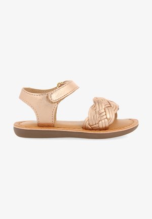 Metallic rose gold sandal with a braided front detail, adjustable ankle strap, flat sole, and a smooth leather finish.