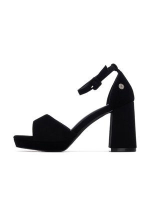 Sandalias de tacón alto de ante negro con un tacón ancho de bloque, tira frontal con punta abierta y una correa en el tobillo con detalle de hebilla.