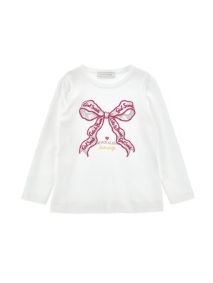 White long-sleeve shirt with a large pink bow design in the center, featuring the text "Girl Scout" and "Cute & Brave" on the ribbon.